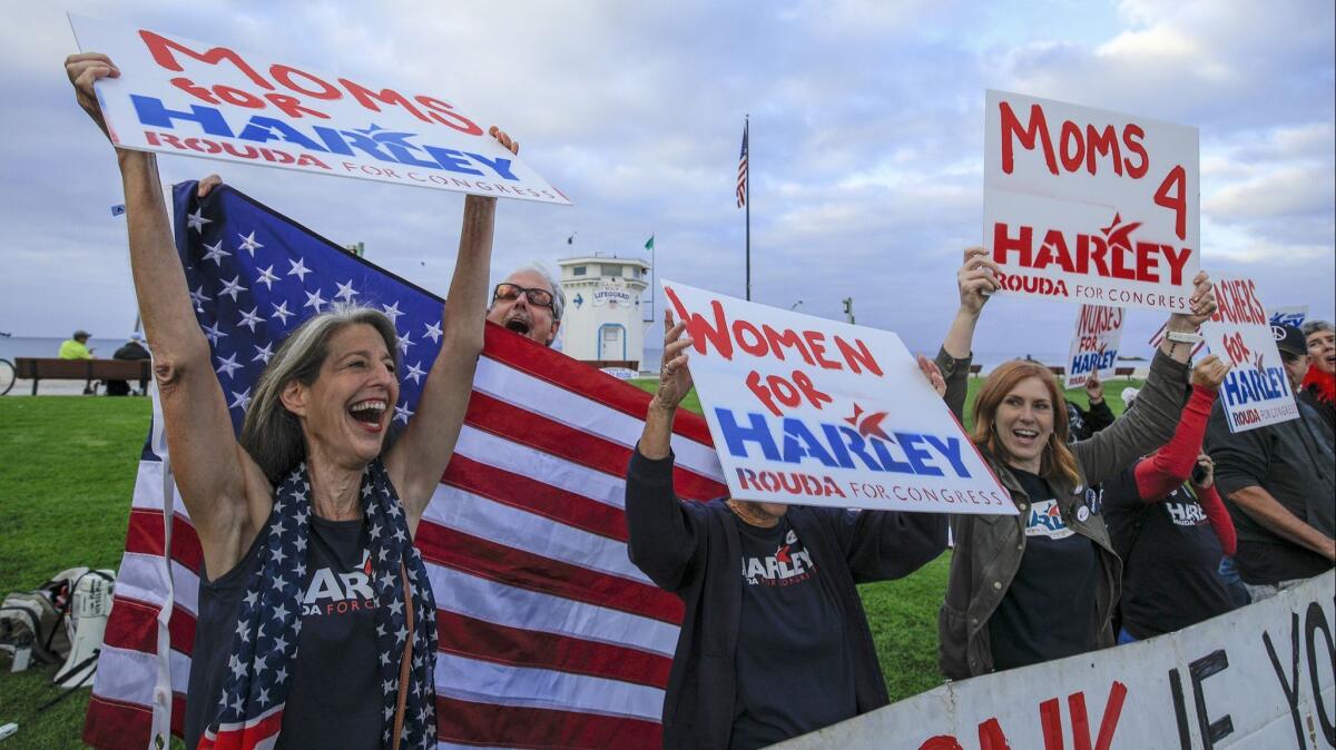 Supporters of Harley Rouda shout for their candidate during a get out the vote rally at Main Beach in Laguna Beach, Calif. on Nov. 6.