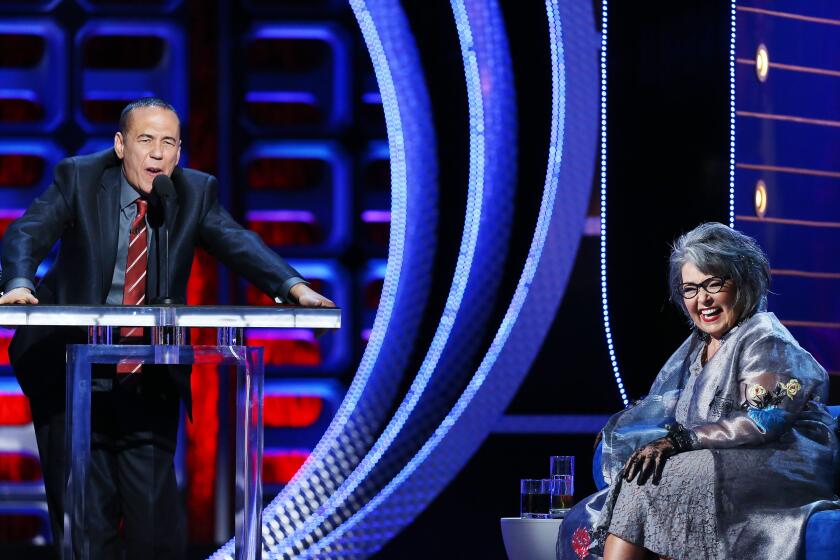 HOLLYWOOD, CA - AUGUST 04: Gilbert Gottfried (L) and Roseanne Barr speak onstage at the Comedy Central Roast of Roseanne Barr held at Hollywood Palladium on August 4, 2012 in Hollywood, California. (Photo by Michael Tran/FilmMagic)