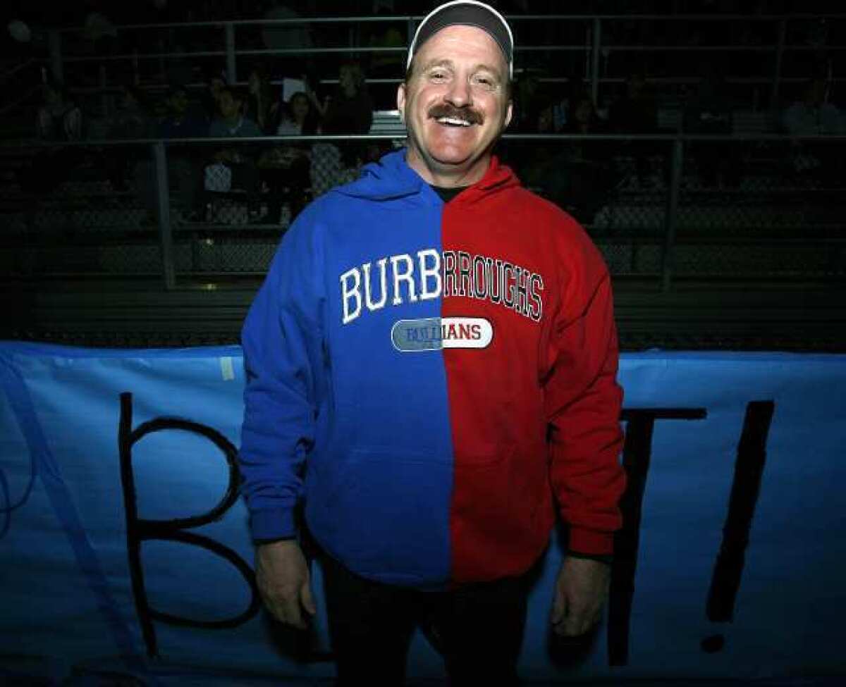 Burbank Unified School District Supt. Stan Carrizosa didn't pick sides and showed his support for both teams in a Pacific League football game at Arcadia High School. Carrizosa is leaving the district to become president of College of the Sequoias.