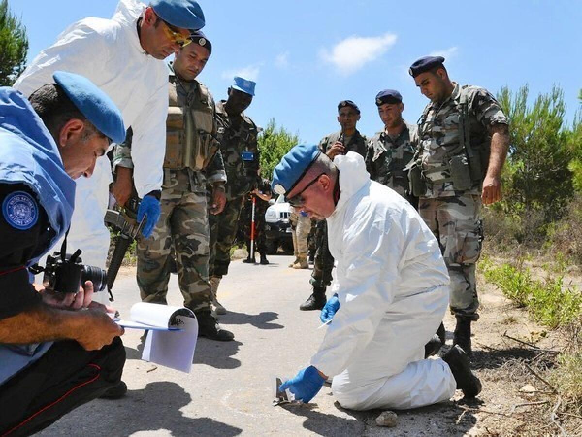 United Nations investigators examine the scene of an explosion Aug. 7 in Lebanon that injured four Israeli soldiers. A U.N official called the reported Israeli incursion “a serious breach" of the resolution that ended the 2006 conflict between Israel and Hezbollah.