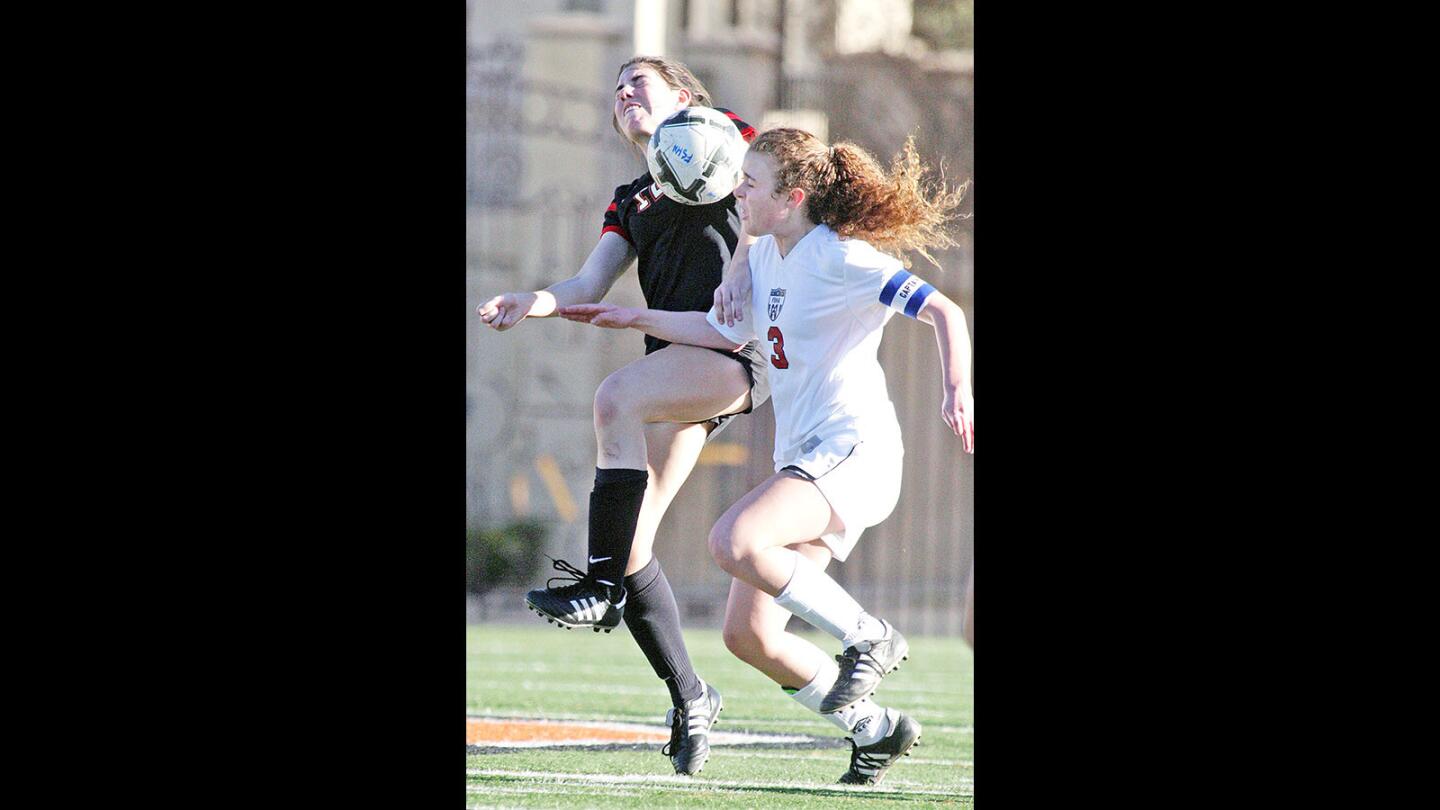 Flintridge Sacred Heart Academy's Lauren Savo battles with Harvard-Westlake's Paige Howard in a Mission League girls' soccer game at Occidental College on Wednesday, Feb. 10, 2016.