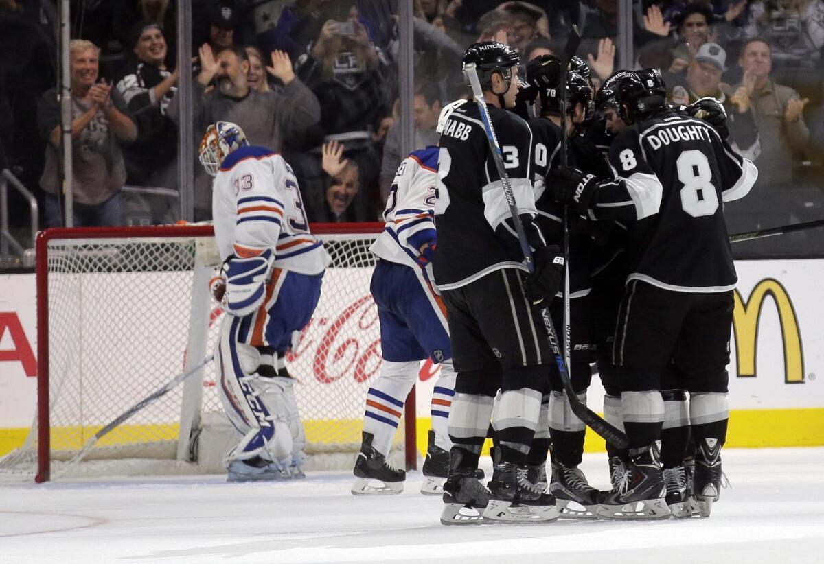 Members of the Kings celebrate after Nick Shore's goal past Edmonton goalie Cam Talbot during the third period on Saturday night.