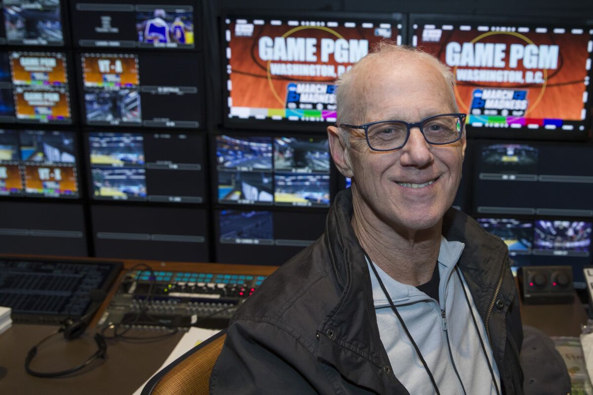 FILE - CBS director Bob Fishman poses in the production truck in Washington on March 28, 2019. Fishman, who has directed the NCAA Tournament since it was acquired by CBS, will direct his last Final Four for CBS and Turner this weekend. The fact that the tournament is in New Orleans is fitting since that is where Fishman's first Final Four took place. (AP Photo/Alex Brandon, File)