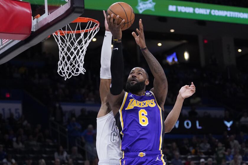 The Lakers' LeBron James drives to the basket against the Thunder's Darius Bazley on Dec. 10, 2021, in Oklahoma City.