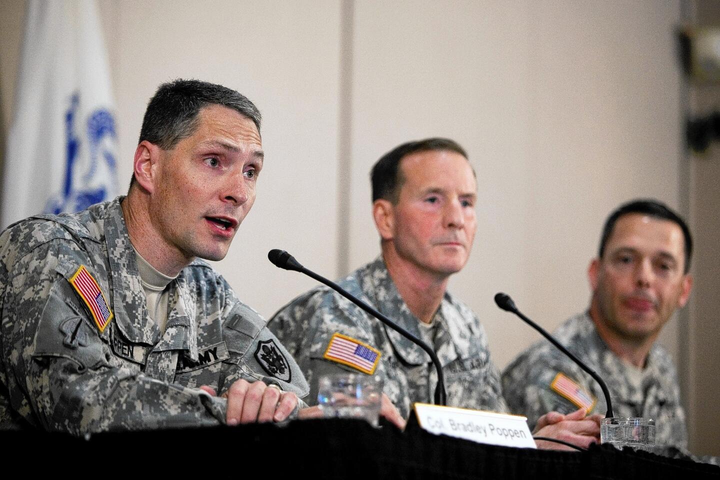 Col. Bradley Poppen, left, Maj. Gen. Joseph P. DiSalvo and Col. Ronald Wool discuss the condition of Sgt Bowe Bergdahl at a news conference at Ft. Sam Houston in San Antonio.