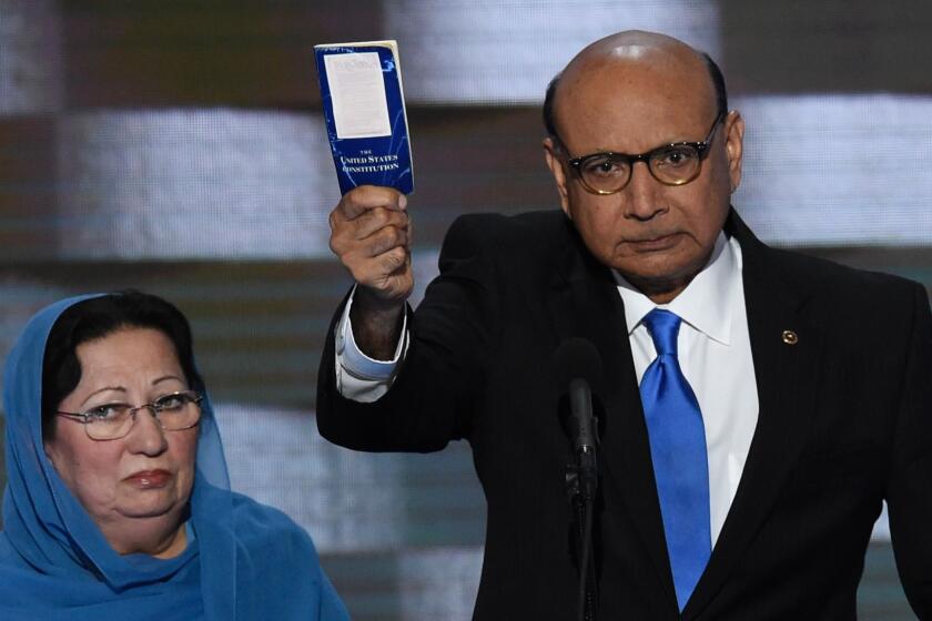 Khizr Khan, with his wife, Ghazala Khan, holds his personal copy of the U.S. Constitution during an appearance at the Democratic National Convention.