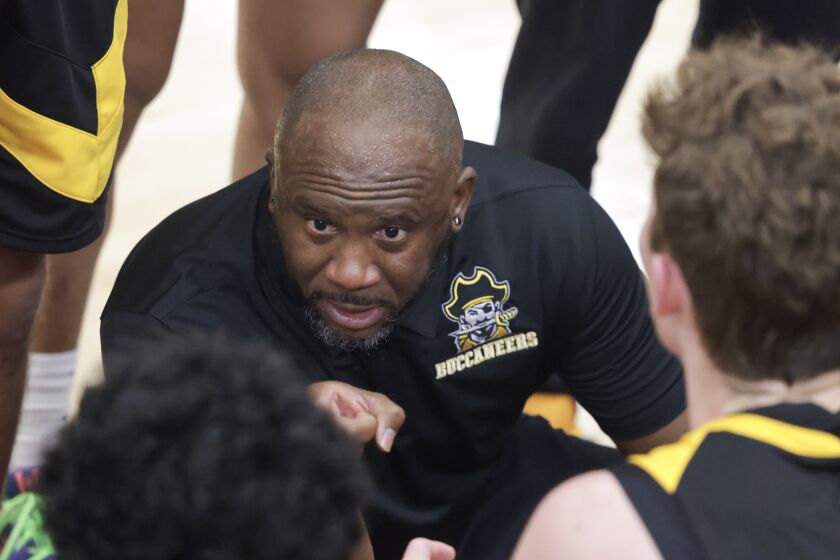 SAN DIEGO, CA - DECEMBER 23, 2022: Mission Bay's head coach Marshawn Cherry talks to his players during a timeout in the second half against Carlsbad during The Holiday Classic's Tip Off Night at Torrey Pines High School in San Diego on Friday, December 23, 2022. (Hayne Palmour IV / For The San Diego Union-Tribune)