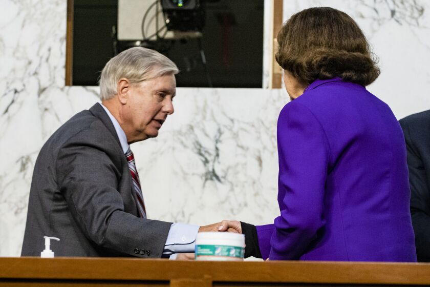 Sen. Lindsey Graham, R-S.C., shakes hands with Sen. Dianne Feinstein, D-Calif., at the close of the confirmation hearing for Supreme Court nominee Amy Coney Barrett, before the Senate Judiciary Committee, Thursday, Oct. 15, 2020, on Capitol Hill in Washington. (Samuel Corum/Pool via AP)