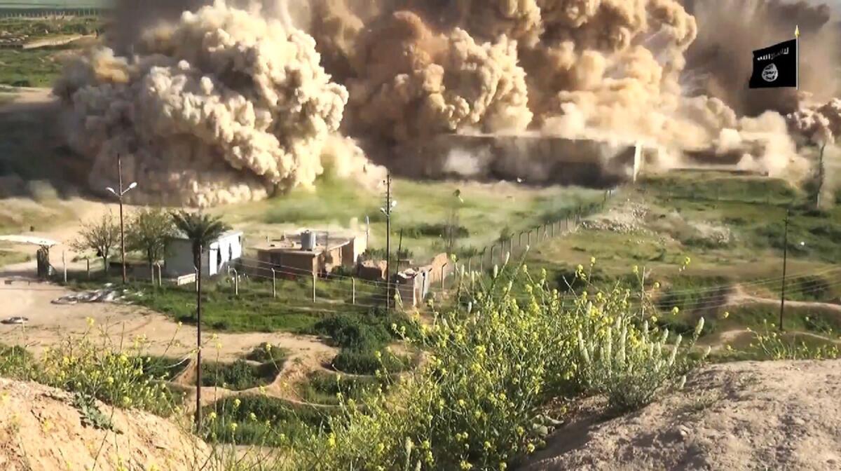 An image taken from a video is said to show smoke billowing from an ancient site in northern Iraq after it was wired with explosives by Islamic State.