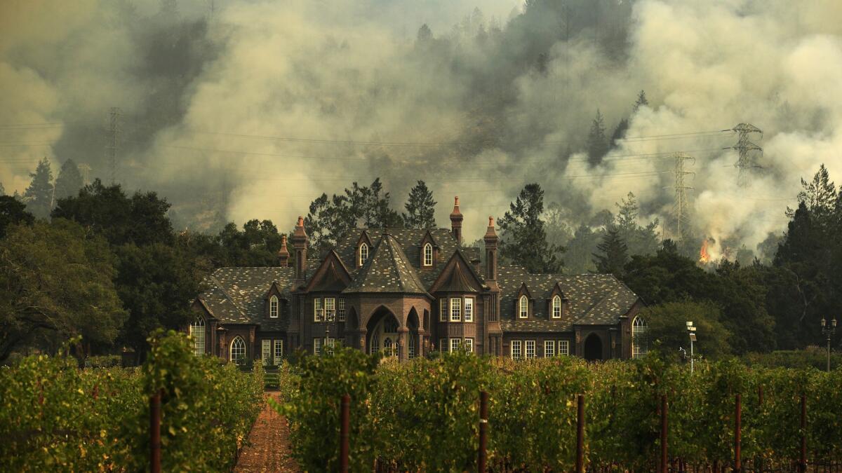 The Tubbs wildfire burns behind a winery in Santa Rosa, Calif. in 2017. State fire authorities last week said that a private electrical system, not PG&E equipment, sparked the Tubbs fire.