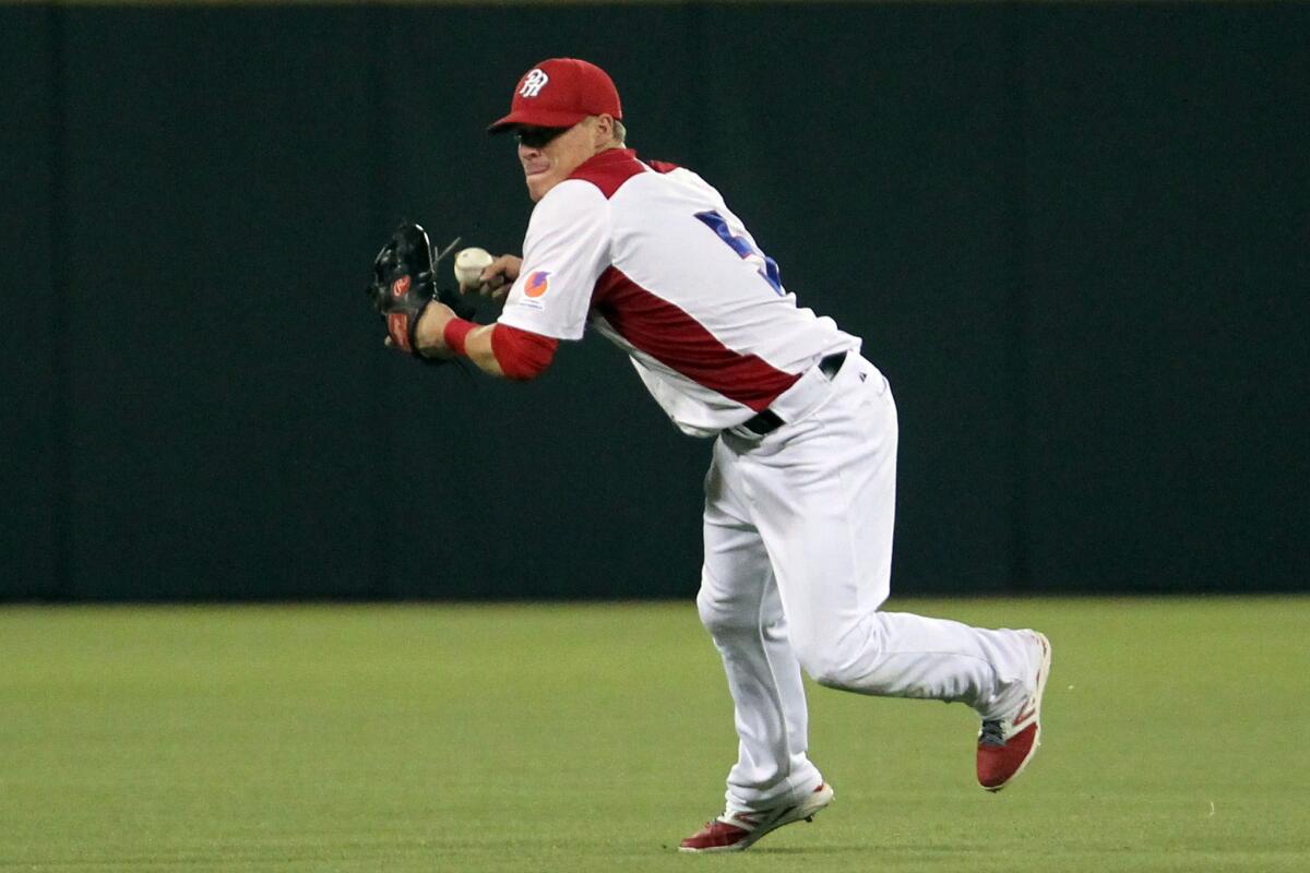 Puerto Rican second baseman Enrique Hernandez prepares to throw to first during a Caribbean Series game against the Dominican Republic on Feb. 6.