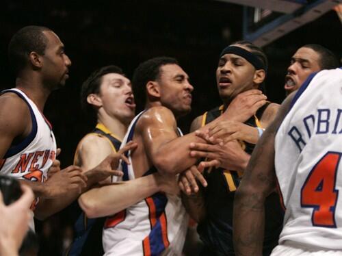 The New York Knicks' Jared Jeffries goes to the throat to restrain Denver's Carmelo Anthony. Jeffries is restrained by the Nuggets' Eduardo Najera as the Knicks' Mardy Collins, left, Channing Frye, second from right, and Nate Robinson, right, look on during the fight at Madison Square Garden.