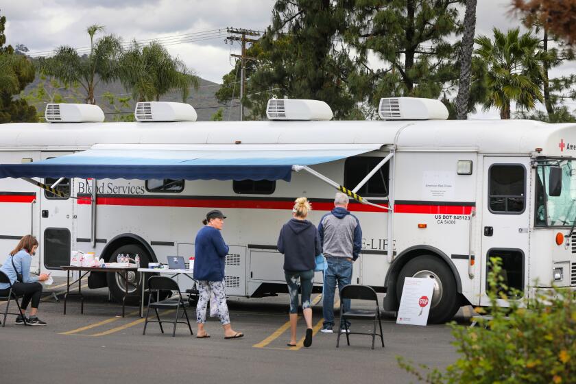 Blood donors wait for their appointments at the American Red Cross Bloodmobile in the parking lot of the CVS store, 572 Fletcher Parkway, March 25, 2020 in El Cajon, California. The event was by appointment only, and a maximum of 30 donors were allowed for the day. The full day was booked according to Red Cross officials.