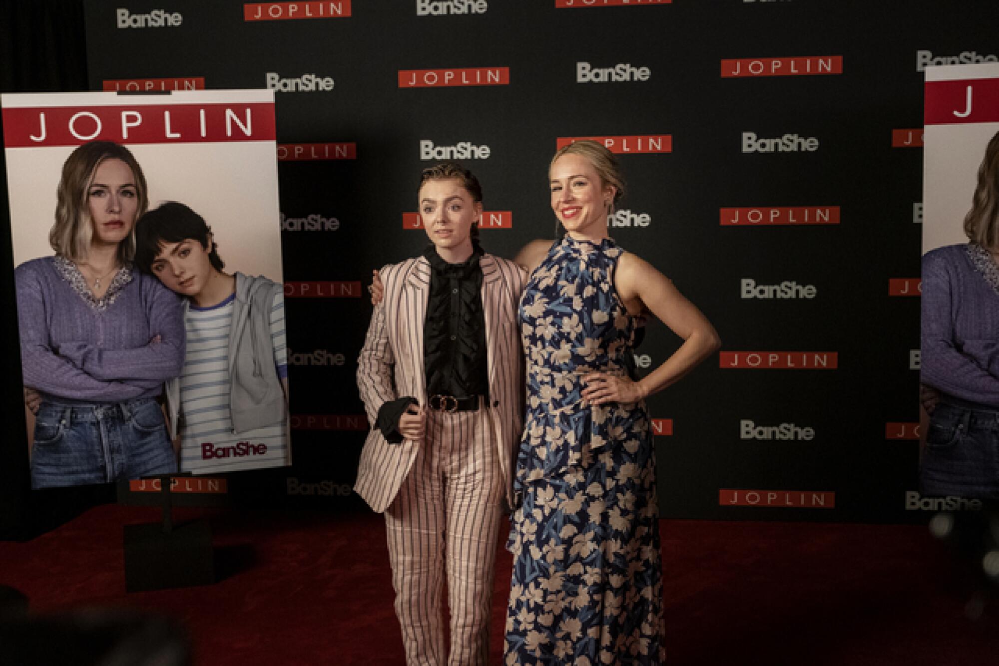 Two women pose on the red carpet at a streaming TV show premiere.
