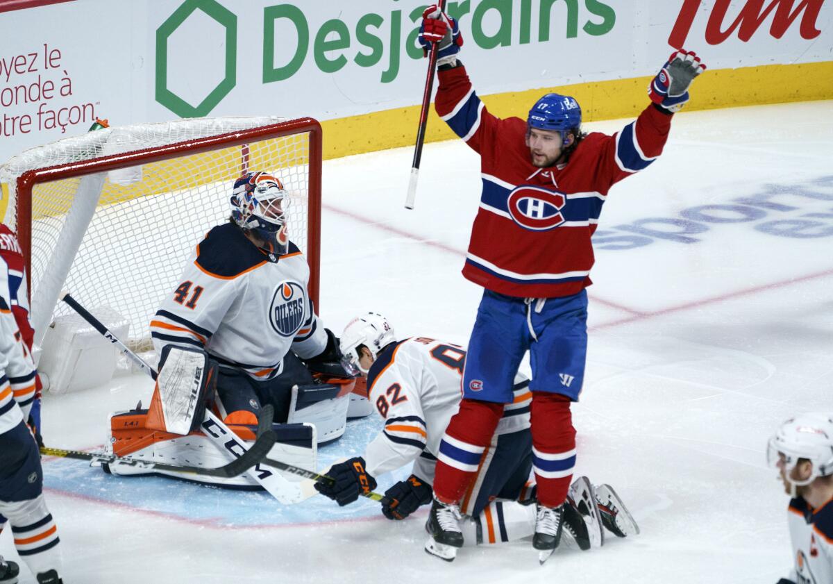 Montreal Canadiens' Josh Anderson celebrates his goal past Edmonton Oilers goaltender Mike Smith during the third period of an NHL hockey game in Montreal on Monday, April 5, 2021. (Paul Chiasson/The Canadian Press via AP)