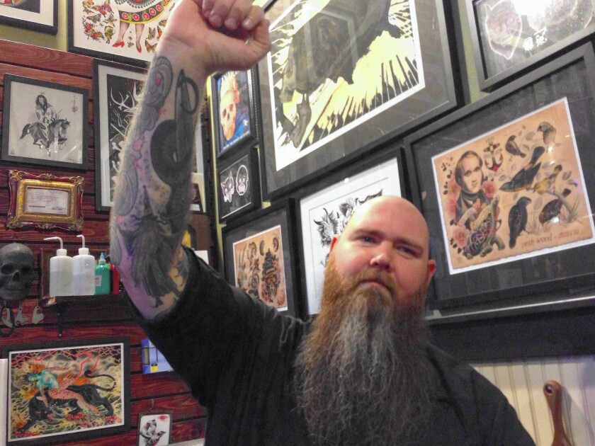 Scapegoat Tattoo owner Brian Thomas Wilson, whose latest tattoo is of a wizard done in animal-free ink, moved his parlor to the mini-mall with other vegan business owners in 2007.