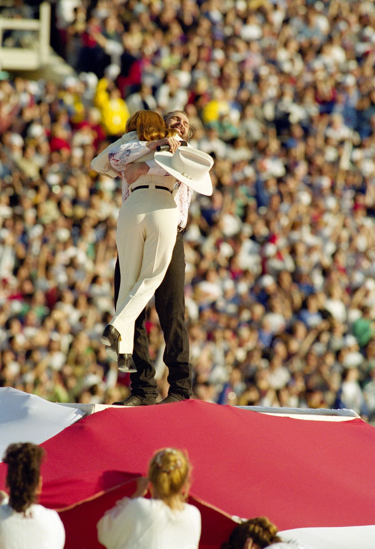 Garth Brooks and Marlee Matlin hug after performing the national anthem at Super Bowl XXVII.