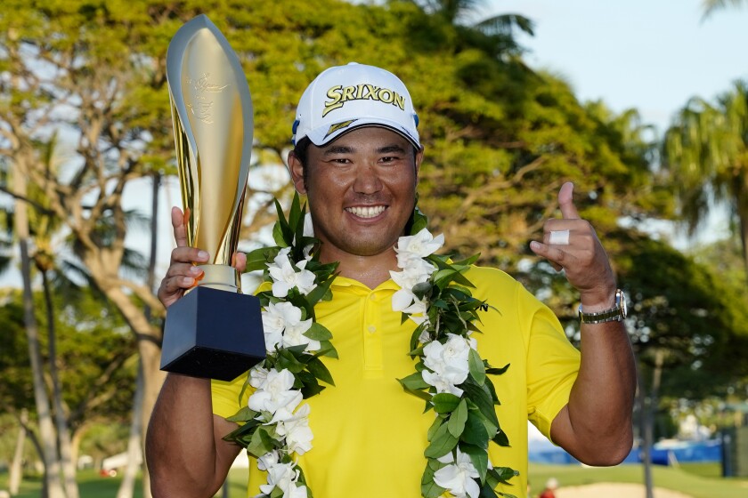 Hideki Matsuyama, of Japan, holds the champions trophy after the final round of the Sony Open golf tournament, Sunday, Jan. 16, 2022, at Waialae Country Club in Honolulu. (AP Photo/Matt York)