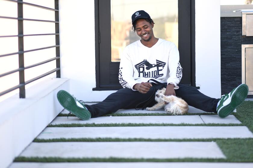 VENICE, CALIFORNIA MAY 21, 2020-NBA player Moe Harkless spends time at home with his dog in Venice as he awaits the restart of the NBA season. (Wally Skalij/Los Angeles Times)