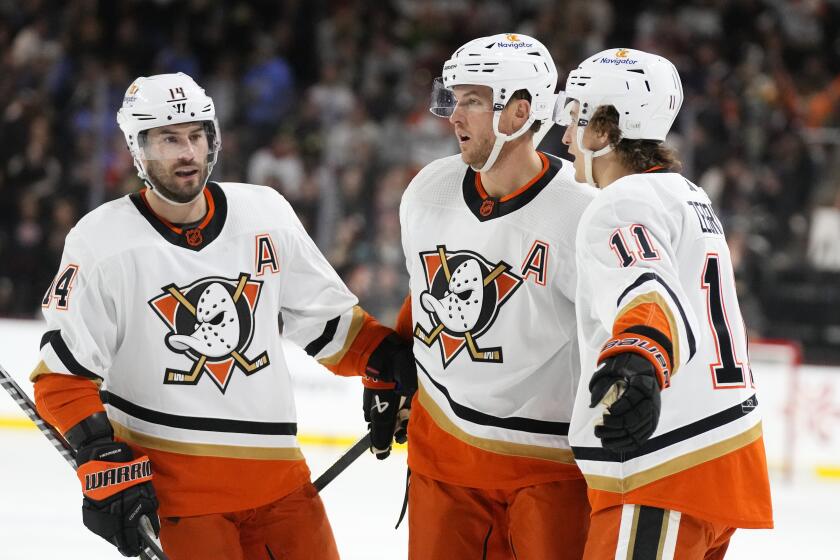 Anaheim Ducks defenseman Cam Fowler celebrates his goal against the Arizona Coyotes with centers Adam Henrique (14) and Trevor Zegras (11) during the second period of an NHL hockey game in Tempe, Ariz., Tuesday, Jan. 24, 2023. (AP Photo/Ross D. Franklin)