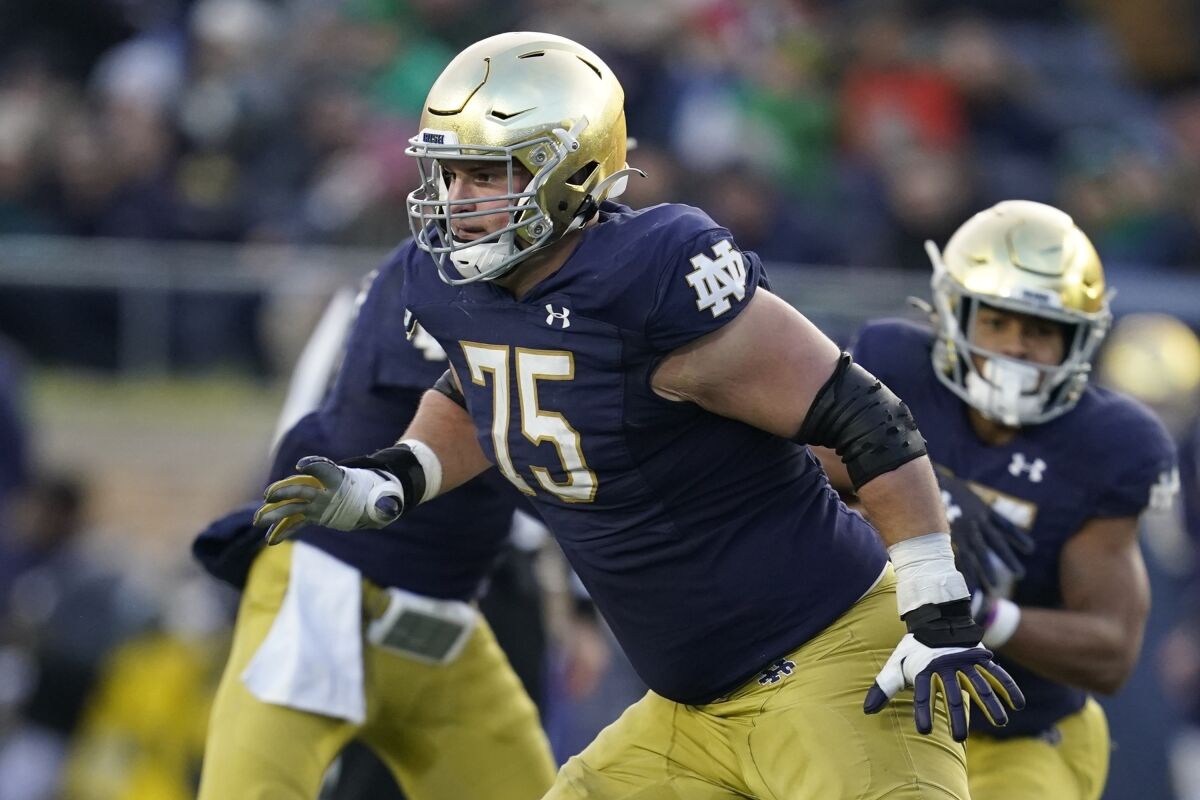 FILE - Notre Dame offensive lineman Josh Lugg (75) plays during the second half of an NCAA college football game, Saturday, Nov. 20, 2021, in South Bend, Ind. First-year Notre Dame football coach Marcus Freeman knows success in the 2022 season will depend on how strong the Fighting Irish will be on the offensive and defensive lines. (AP Photo/Darron Cummings, File)