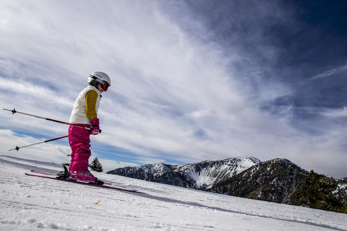 MT. BALDY, CALIF. -- SATURDAY, JANUARY 18, 2020: A young skier navigates a run with a view of Mt. Baldy, right, at the ski resort in Mt. Baldy, Calif., on Jan. 18, 2020. (Brian van der Brug / Los Angeles Times)