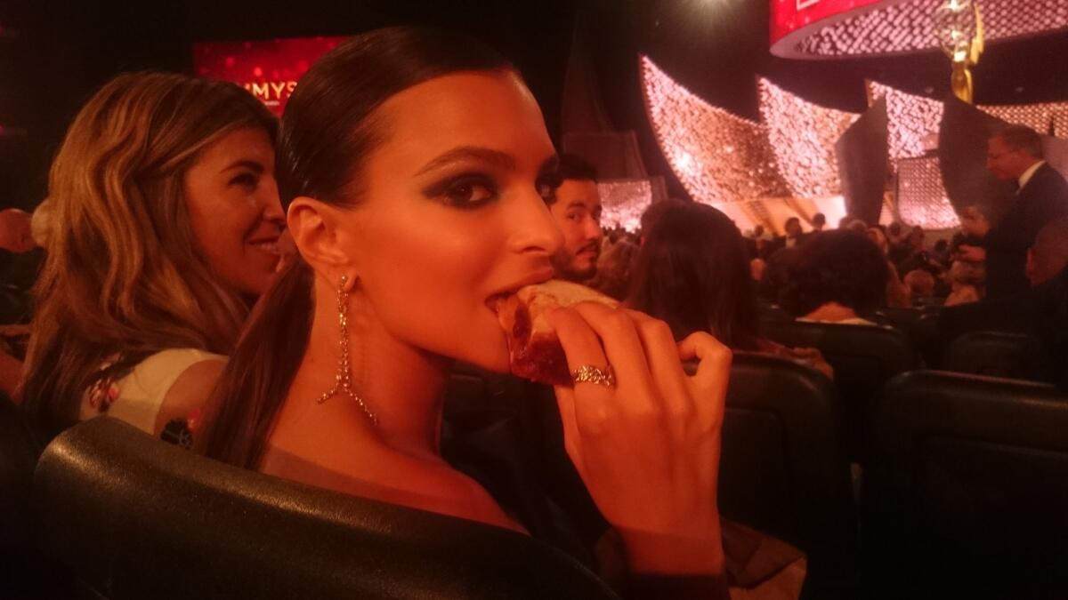 Emily Ratajkowski eats her peanut butter and jelly sandwich at the Emmy Awards.