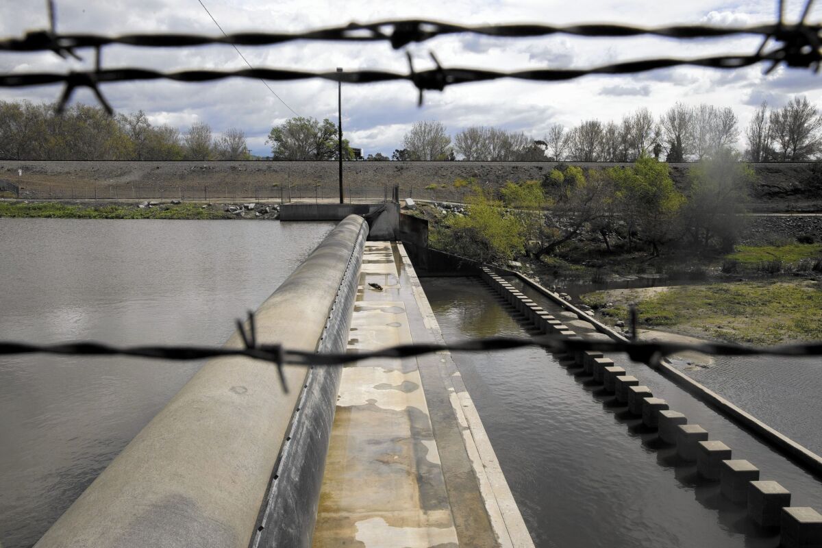 An inflatable dam diverts water from the San Gabriel River to a spreading ground in Pico Rivera.