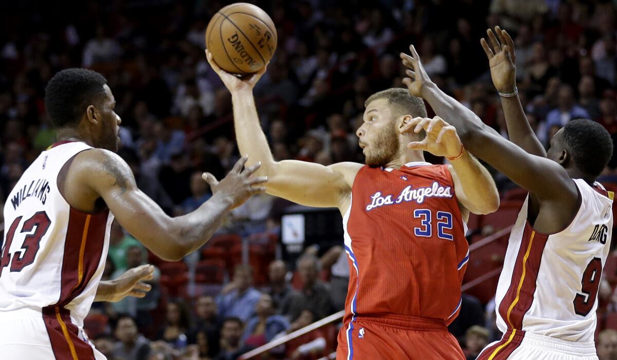 Clippers power forward Blake Griffin looks to pass against the double-team defense of Heat forwards Shawne Williams (43) and Luol Deng (9) on Thursday night in Miami.