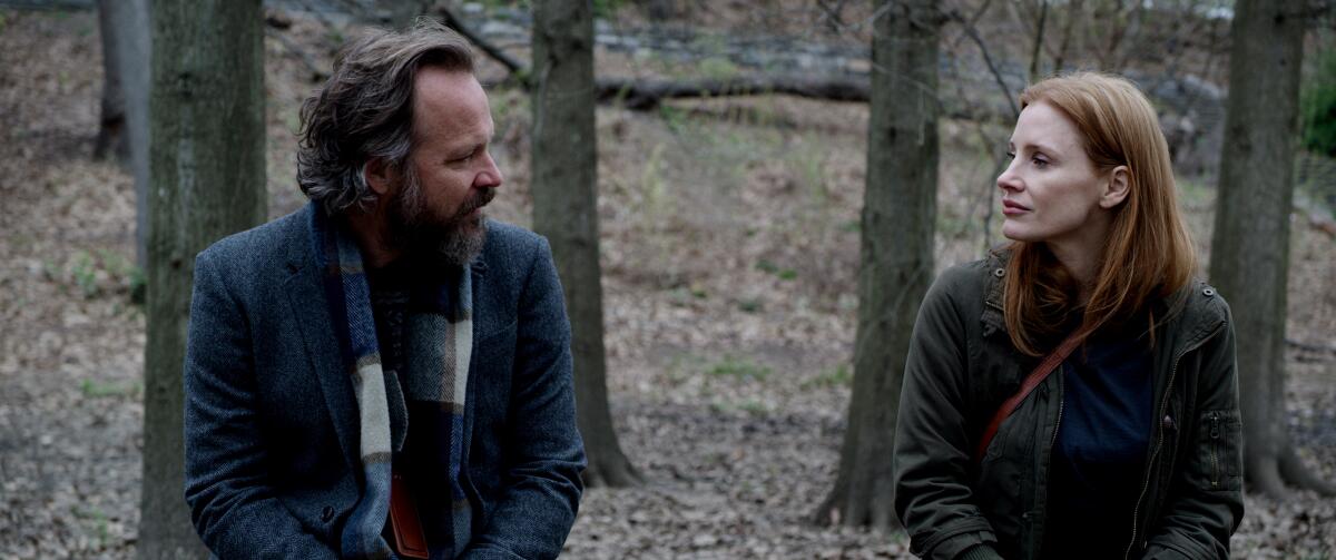 Peter Sarsgaard and Jessica Chastain sit outside on a bench in "Memory."