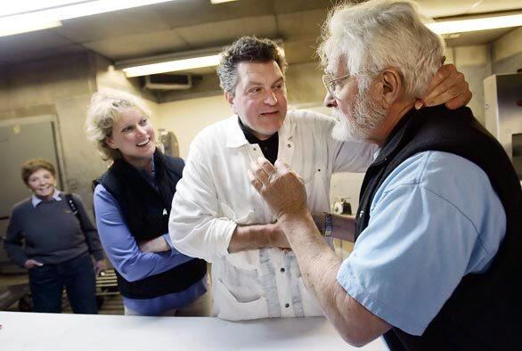 Italian butcher Dario Cecchini, center, and local butcher Harvey Gussman talk shop at Guss Meat Co. in Los Angeles.