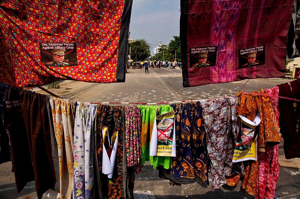 A line of sarongs cordons off a road.