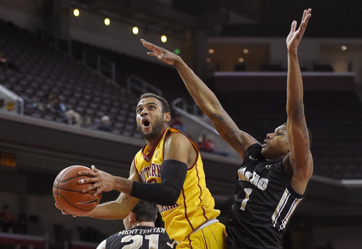 USC guard Julian Jacobs, left, shoots as Idaho guard Perrion Callandret defends during the second half.