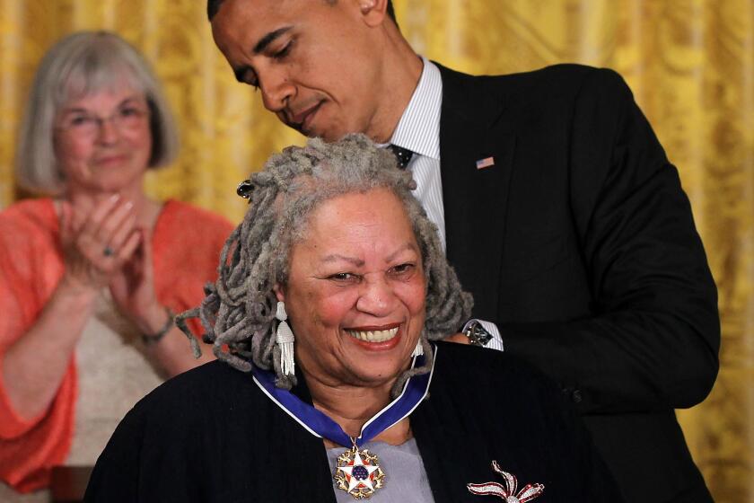 Toni Morrison receives the Presidential Medal of Freedom from President Obama in 2012.