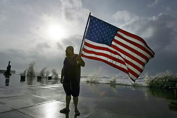 Robert Shumake makes a stand on the Galveston, Texas, sea wall as waves roll in from Hurricane Ike.