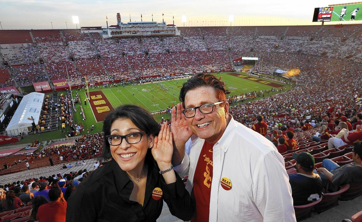 Elizabeth Valmont, an acoustical consultant, and university architect Jon Soffa, attend a USC football game this month at the Los Angeles Memorial Coliseum.