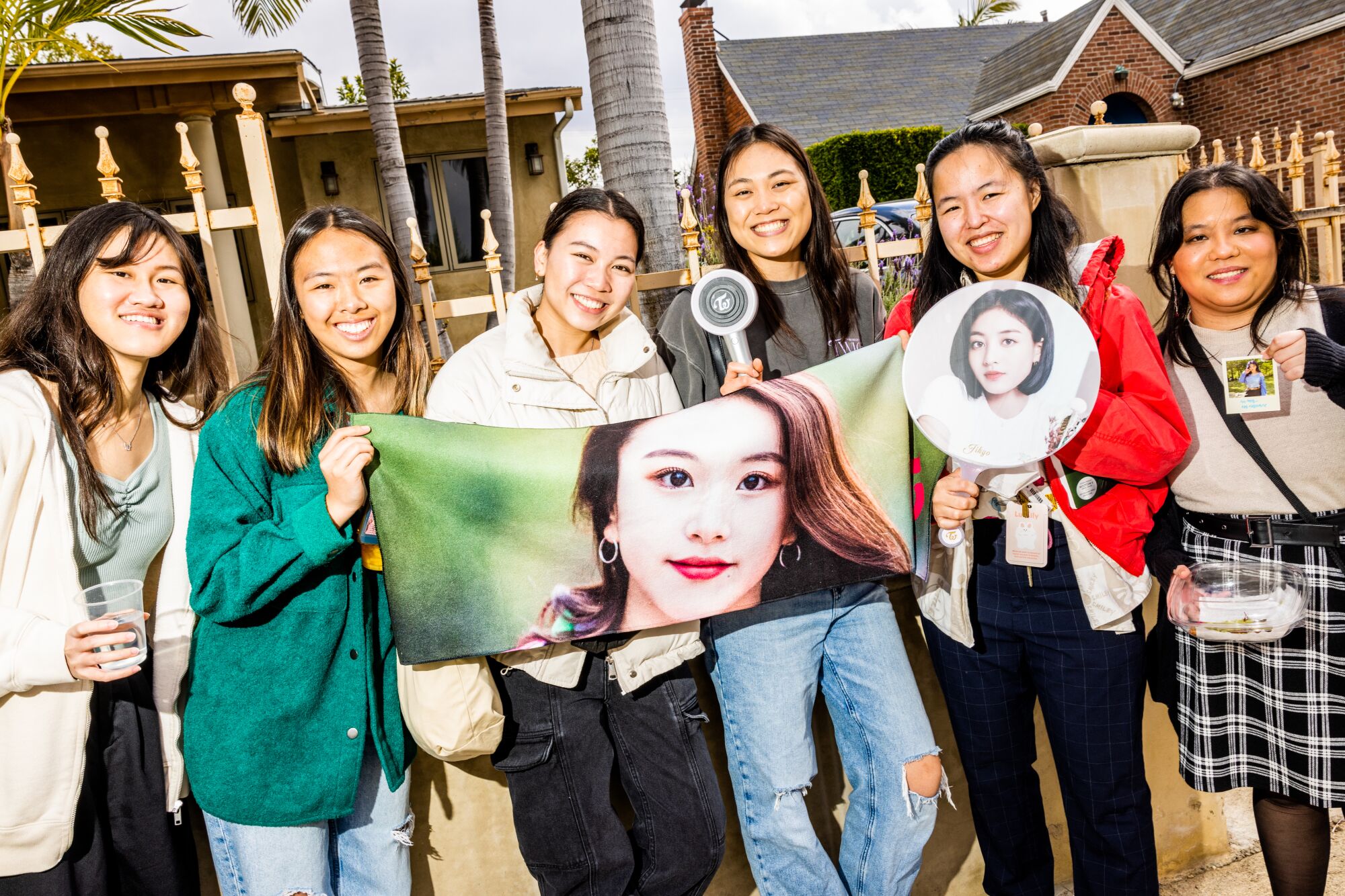 Fans show off their wares as they line up.