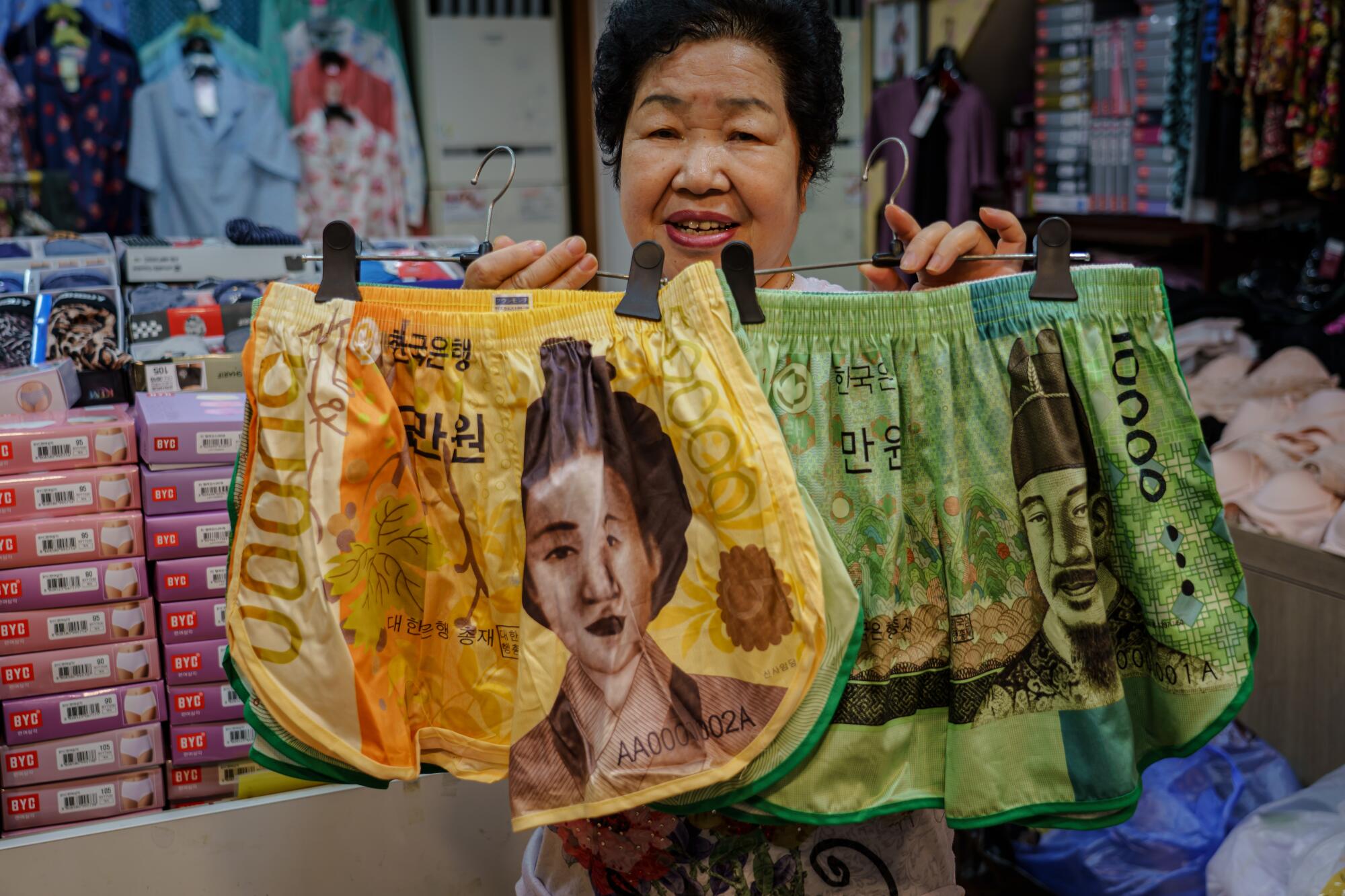 Shin Soon-nam displays shorts decorated with images from South Korean currency. 