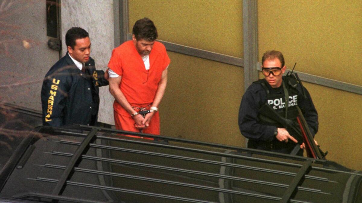 Ted Kaczynski is escorted outside the federal courthouse in Sacramento in 1998.
