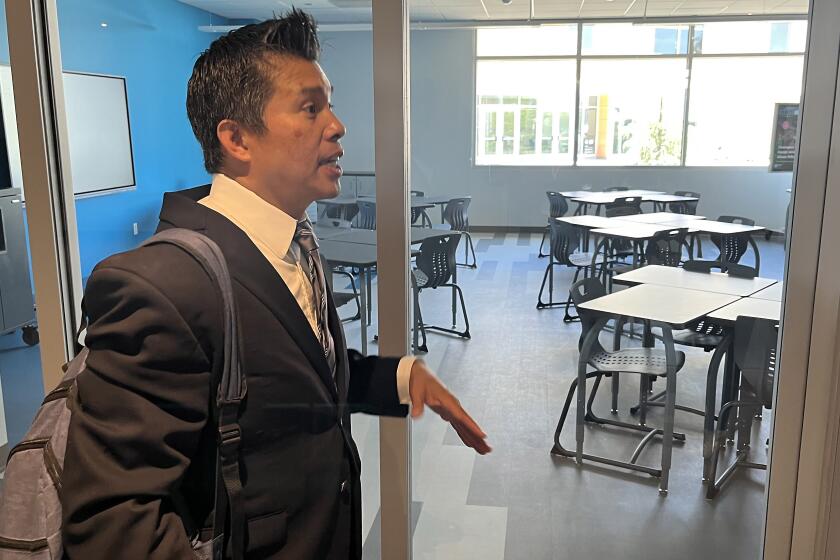 Principal Larry Natividad stands outside a new Compton High classroom.