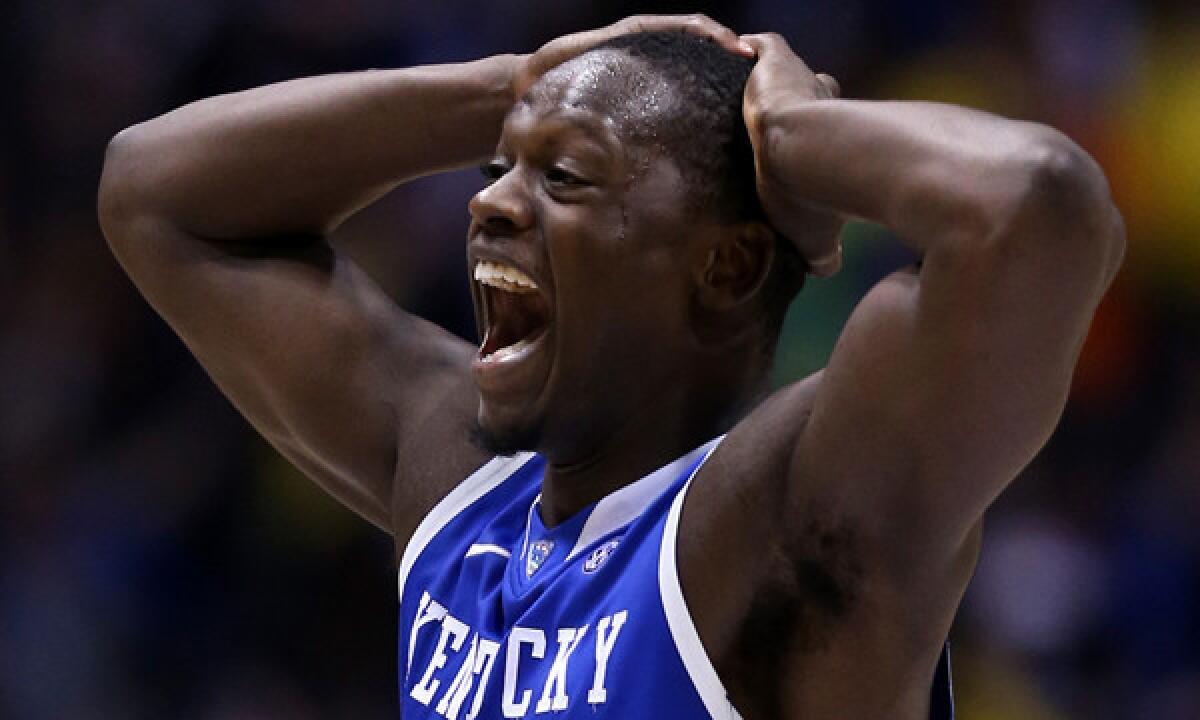 Kentucky's Julius Randle celebrates following the Wildcats' 75-72 victory over Michigan in the Midwest Regional final.