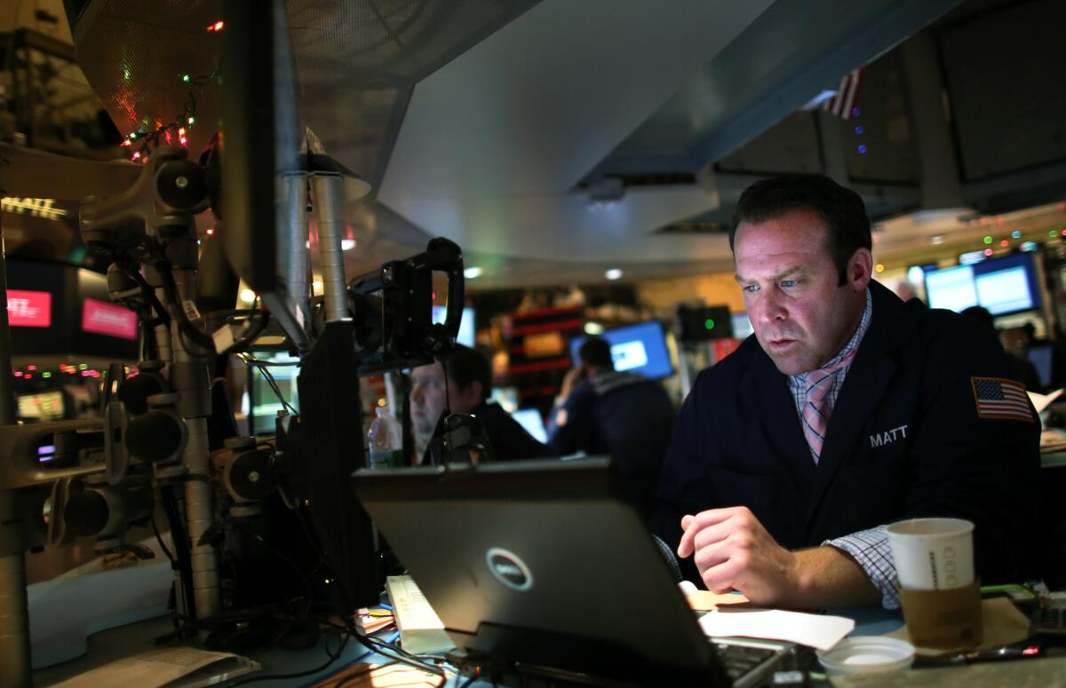 A trader works on the floor of the New York Stock Exchange. The Dow Jones industrial average fell 331.34 points on Monday, the steepest single-day slide since early October.