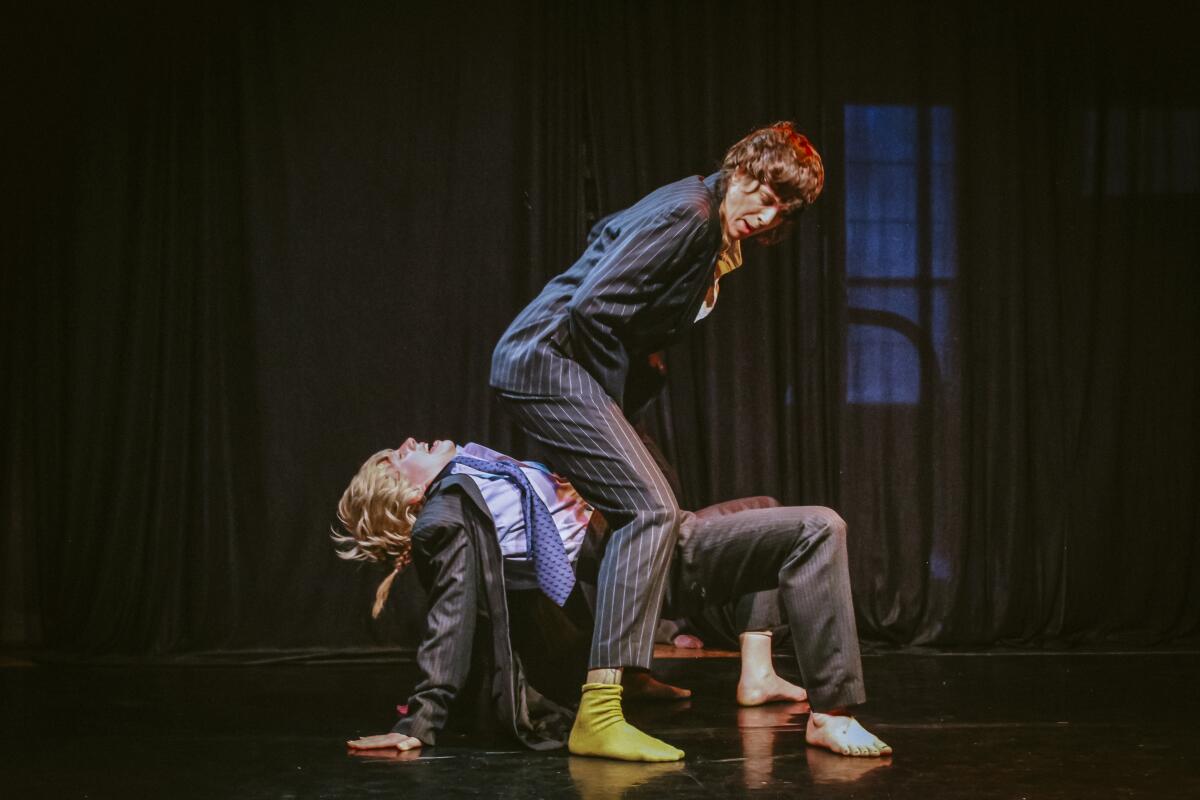 Two performers in wigs in a funny position