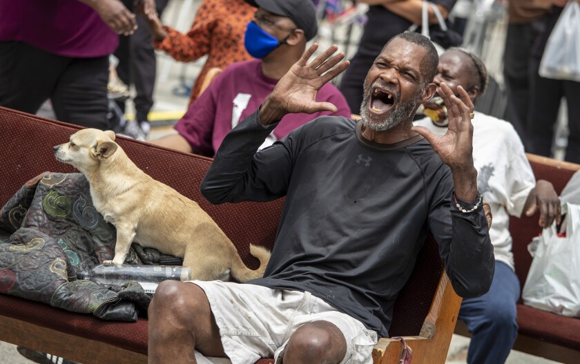 Gerald Hunter sings along with entertainer Rickie Byars in Leimert Park