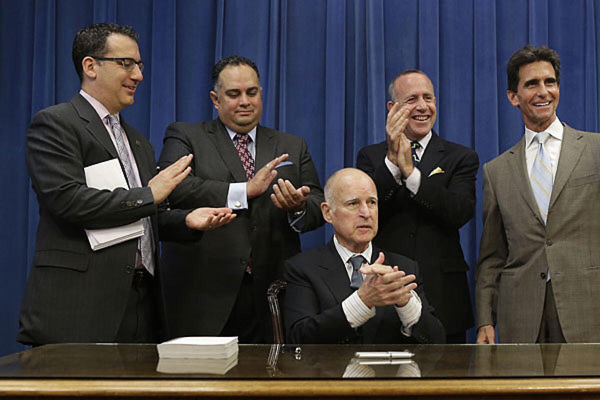 Assemblyman Bob Blumenfield (D-Woodland Hills), left, Assembly Speaker John Perez (D-Los Angeles), Senate President Pro Tem Darrell Steinberg (D-Sacramento) and Sen. Mark Leno (D-San Francisco) applaud after receiving a copy of the state budget presented by Gov. Jerry Brown last year.