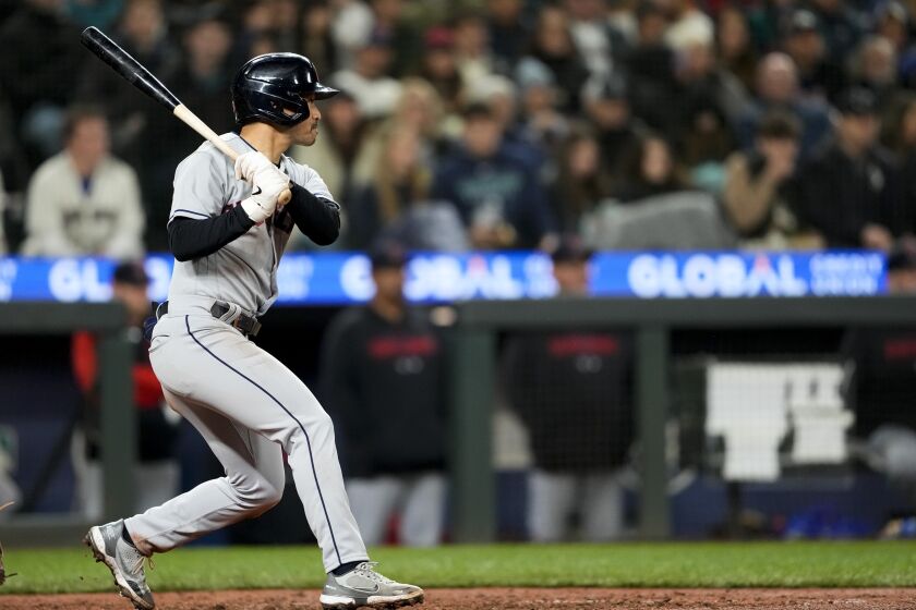 Cleveland Guardians' Steven Kwan follows through on a two-run single against the Seattle Mariners during the fifth inning of a baseball game Friday, March 31, 2023, in Seattle. (AP Photo/Lindsey Wasson)