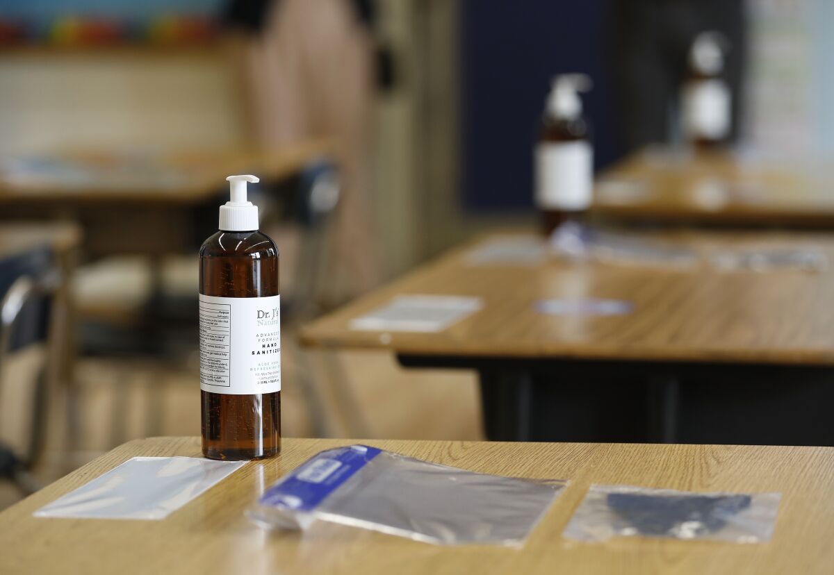 Hand sanitizer and masks on desks at an L.A. elementary school.
