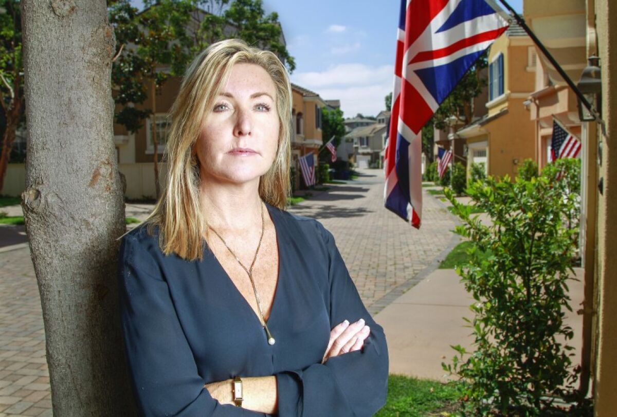 Shannon Glover stands near the British flag her Carmel Valley HOA has ordered her to remove.
