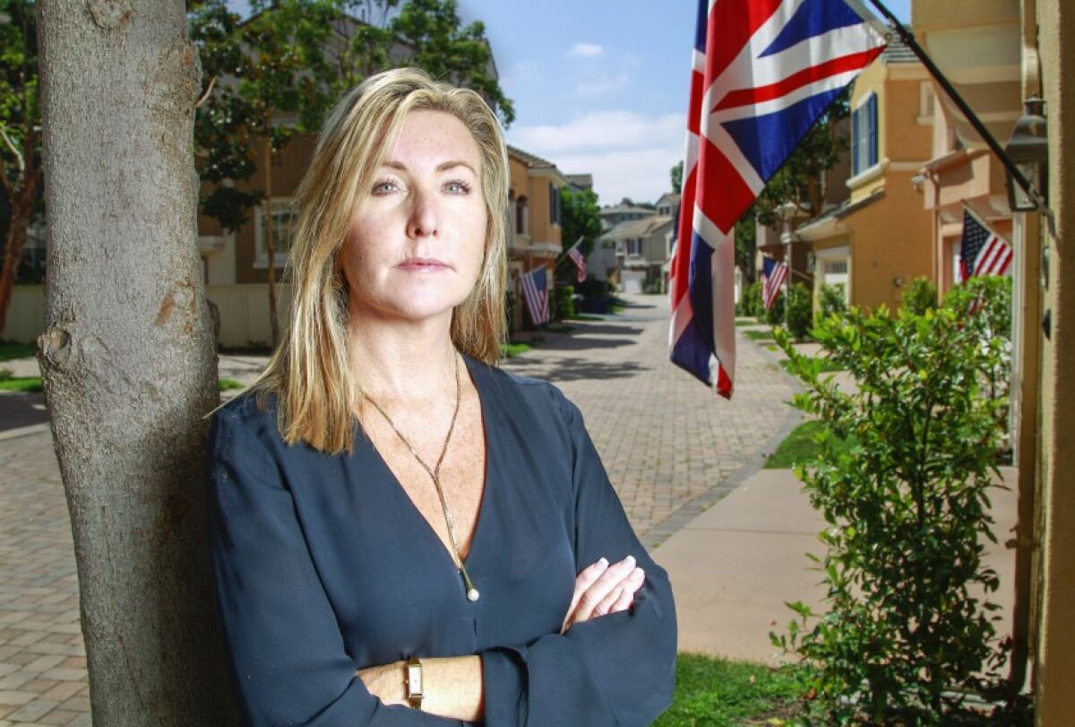 Shannon Glover stands near the British flag her Carmel Valley HOA has ordered her to remove.