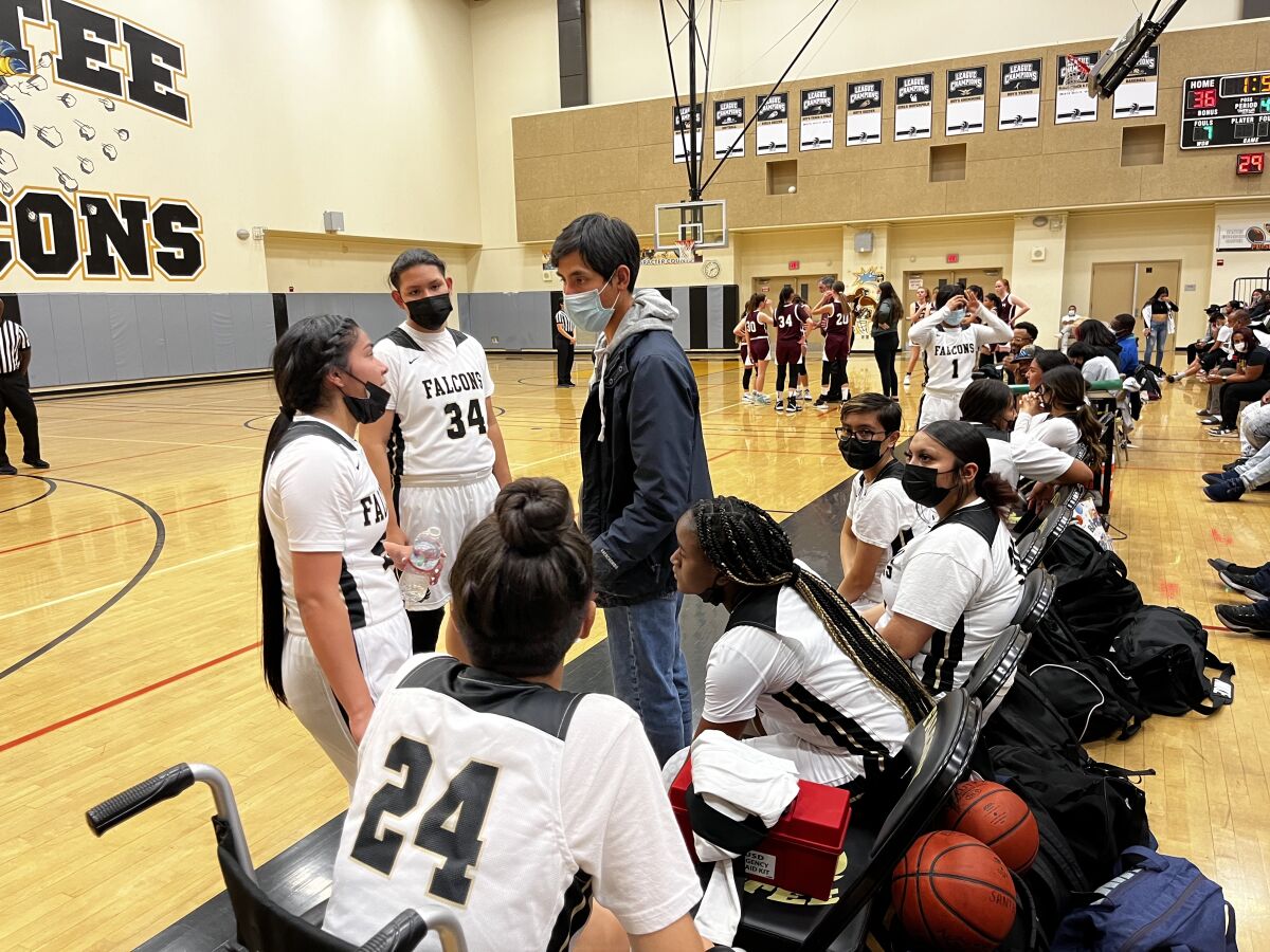 Santee girls' basketball coach Marcus Droz speaks to Marlissa Pecheco and other players during a recent game.